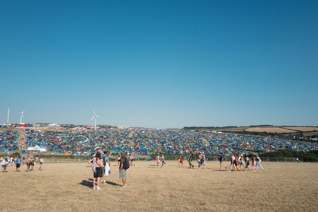 people overlooking a festival campsite