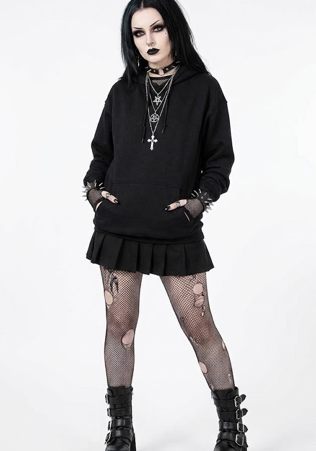 Woman wearing fishnets, skirt, hoodie and jewellery